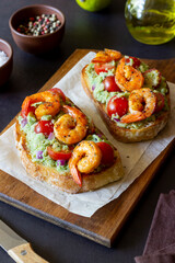 Bruschetta with shrimp, guacamole and tomatoes. Healthy eating. Breakfast.
