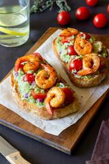 Bruschetta with shrimp, guacamole and tomatoes. Healthy eating. Breakfast.
