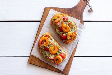 Bruschetta with shrimp, guacamole and tomatoes. Healthy eating. Breakfast.