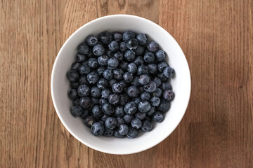 A bowl of blueberry on the wooden table