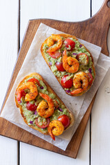 Bruschetta with shrimp, guacamole and tomatoes. Healthy eating. Breakfast.