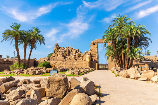 Remains of Karnak Temple with palms and stones, Luxor, Egypt