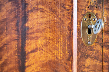 aged rustic and vintage golden brown closet with keyhole. backdrop and background concept.
