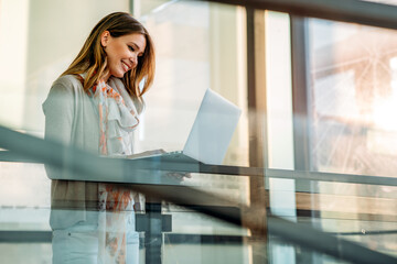 Happy successful businesswoman remote working on laptop: People business work technology concept.