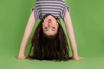 Upside down view portrait of attractive amazed girly funny girl standing on hands pout lips...