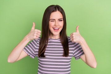 Portrait of attractive cheerful brown-haired girl showing double thumbup ad winking isolated over...