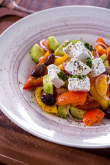 Salad with cheese, olives, onions, tomatoes, peppers, lettuce and sauce