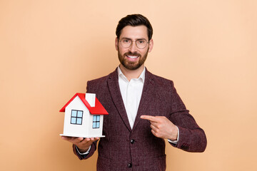 Photo of young stylish businessman promote his services as retail manager isolated on beige color background