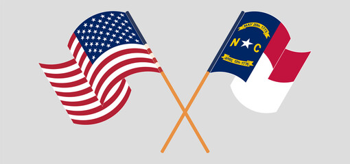 Crossed and waving flags of the USA and The State of North Carolina