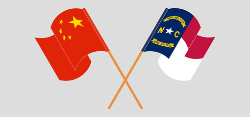 Crossed and waving flags of China and The State of North Carolina