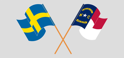 Crossed and waving flags of Sweden and The State of North Carolina