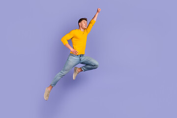 Full size profile side photo of young man jump up fly help protection strong isolated over violet...