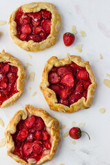 Mini-biscuits made of strawberries on a white background. Delicious mini-pies. Top view