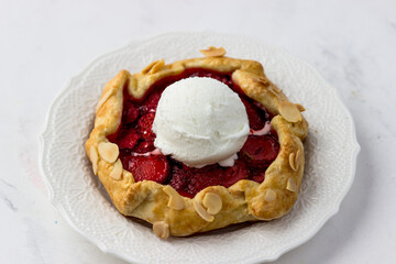 Mini biscuit with strawberries and a ball of ice cream. Delicious berry pie on a white background