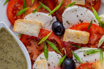 Salad with mozzarella cheese, olives, croutons, tomatoes and onions