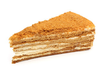 Slice of honey cake with cream (medovik) on white background