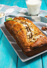 Banana bread or cake on blue wooden table. Delicious homemade dessert or morning breakfast.