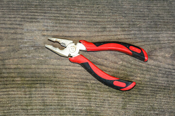 Old pliers with plastic handles.