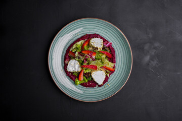 Salad with cheese, strawberries, lettuce, endive, jam and chopped nuts
