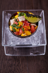 Salad with mango, sesame, lemon, parsley, mango, thyme, grapefruit and fish