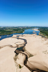 Low water level in Vistula river, effect of drought seen from the bird's eye perspective. City...