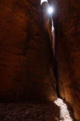 Sun shining through the Echidna Chasm in the Bungle Bungle National Park, or Purnululu, in the Kimberley region of Western Australia
