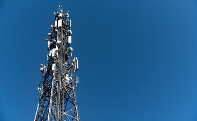 Cell phone relay tower. Metal mast. Metal structure with mounted relays. Steel structure against...