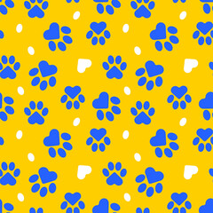 Paws of a cat, dog, puppy. Seamless cute pattern of animal footprints for textile. Blue and yellow colors. Vector.