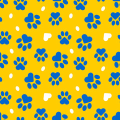 Paws of a cat, dog, puppy. Seamless cute pattern of animal footprints for textile. Blue and yellow colors. 
