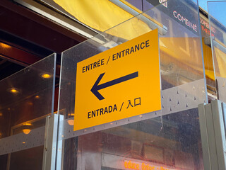 Multilingual entrance sign of the Eiffel Tower in Paris, France