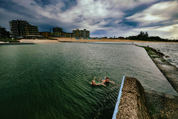 Kids swimming in the Ocean Baths swimming pool at Forster, NSW Australia