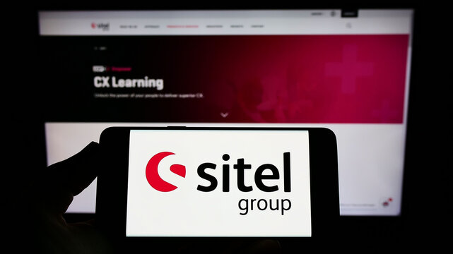 Stuttgart, Germany - 07-03-2022: Person holding smartphone with logo of US contact center company Sitel Group on screen in front of website. Focus on phone display.