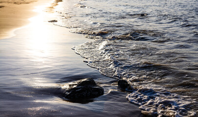 Waves playing in the sand at Pender Bay, towards Cape Leveque in the Kimberley region of Western Australia