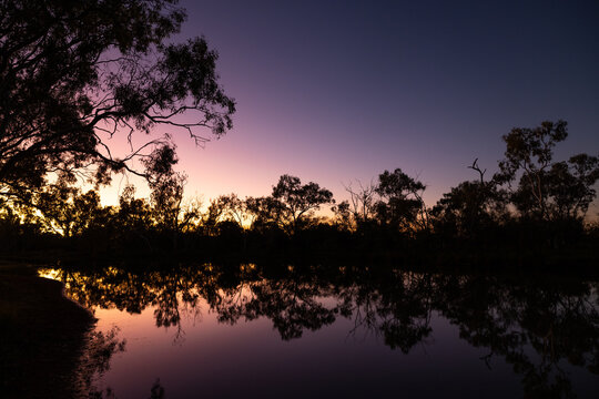 Amazing sunrise with reflections over the remote Bilyuin Pool, Meekatharra, Western Australia