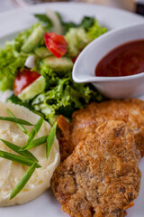 Pork chops with mashed potatoes and salad