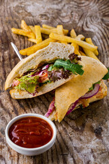 Sandwich with vegetables and fries