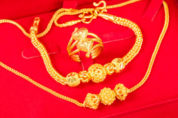 The Gold Bracelet in red velvet box container.