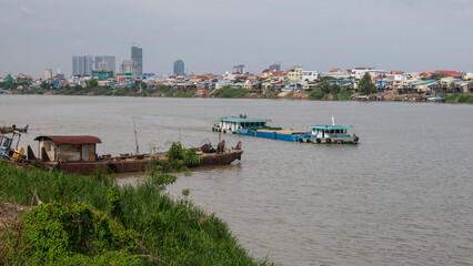 Boats and pontoons on the Bassac River in Phnom Penh, Cambodia. November 2019