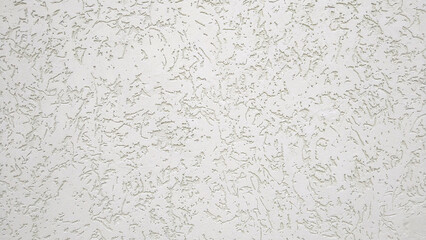 Texture of white ribby stucco on cement wall.
