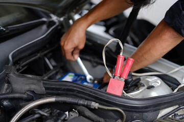 change car battery, mechanic is checking the engine
