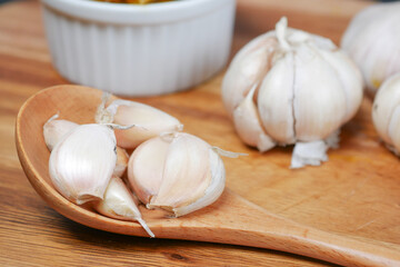 close up pf garlic on a wooden spoon on table 