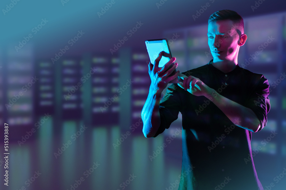 Poster man with tablet. engineer in front of server equipment. guy works as system administrator. system ad