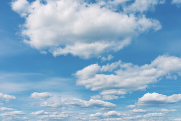 White clouds in the blue sky. White light cloudy heaven,good weather. Summer sky. Heaven and infinity. Curly clouds on a sunny day. Beautiful bright blue background.