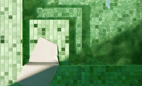 Top View Of Green Tiled Indoor Pool With A White Towel