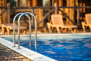 Top view of swimming pool with clear water on vacation on sunset background