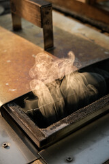 Wood smoke is seen coming out of a hot tub stove