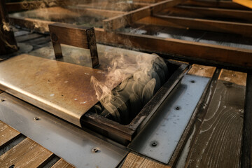Wood smoke is seen coming out of a hot tub stove