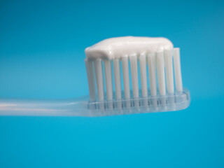 Toothbrush with copy space on blue background.