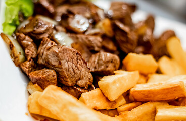 Portion of noble meat with a ipim side of fried in a Brazilian Pub Bar