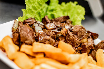 Noble pork with fried aipim with lettuce salad in a typical Brazilian bar